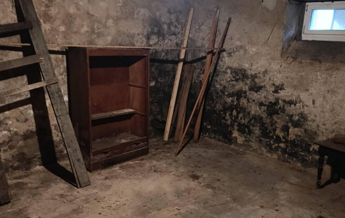 Kellerraum mit altem Schrank und Brettern während einer Entrümpelung